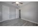 A bright bedroom with fresh gray walls, modern gray floors, and a ceiling fan at 3714 38Th N Ave, St Petersburg, FL 33713