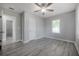 A simple bedroom with ensuite bathroom access featuring a ceiling fan and large windows at 3714 38Th N Ave, St Petersburg, FL 33713