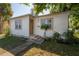 Cozy single-story house with wood siding, a small porch, and a neat, grassy front yard at 3714 38Th N Ave, St Petersburg, FL 33713