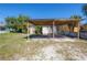 Exterior view of white home featuring a carport and landscaping in the yard at 3714 38Th N Ave, St Petersburg, FL 33713