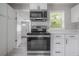 Stylish kitchen featuring stainless steel oven, white cabinetry, and modern backsplash at 3714 38Th N Ave, St Petersburg, FL 33713