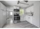 Modern kitchen featuring stainless steel appliances, white cabinets, and sleek gray countertops at 3714 38Th N Ave, St Petersburg, FL 33713