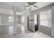 Open kitchen with stainless steel refrigerator, ceiling fan, and views into the living room with light grey flooring at 3714 38Th N Ave, St Petersburg, FL 33713