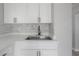 Close up of the stainless steel kitchen sink, modern faucet, and white countertops with mosaic backsplash at 3714 38Th N Ave, St Petersburg, FL 33713