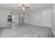 Open-concept living space with light gray flooring and a view into the newly renovated kitchen at 3714 38Th N Ave, St Petersburg, FL 33713