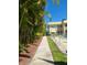 Exterior view along a walkway with beautiful palm trees and a community pool at 3850 13Th N Ave # 101, St Petersburg, FL 33713