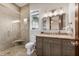 Well-lit bathroom featuring a glass-enclosed shower, custom vanity, and modern fixtures offering a stylish and functional space at 4301 Carson Ne St, St Petersburg, FL 33703