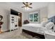 Bright bedroom with neutral tones, natural light, a ceiling fan, and carpet flooring, providing a serene living space at 4301 Carson Ne St, St Petersburg, FL 33703