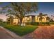 Attractive home featuring verdant landscaping, paved walkway to front door, and charming chairs to relax and unwind at 4301 Carson Ne St, St Petersburg, FL 33703