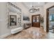 Elegant home foyer showcasing a large mirror, chandelier lighting, and a stylish bench at 4301 Carson Ne St, St Petersburg, FL 33703