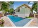 Inviting pool with a tanning ledge and spa complemented by lush landscaping and exterior view of the home at 4301 Carson Ne St, St Petersburg, FL 33703