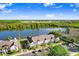 Community aerial view of condominiums overlooking a lake, showcasing verdant landscaping and parking at 435 Kensington Lake Crk, Brandon, FL 33511