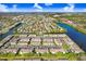 Expansive aerial view showcases a waterfront community with manicured lawns and scenic water features at 435 Kensington Lake Crk, Brandon, FL 33511
