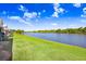 Scenic water view from the backyard with lush green grass in a well-maintained community at 435 Kensington Lake Crk, Brandon, FL 33511