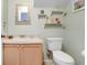 Well-lit half bathroom with a modern vanity, a toilet, and decorative shelves, maximizing space and style at 435 Kensington Lake Crk, Brandon, FL 33511