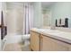 This bathroom has a shower and tub with a white shower curtain and light wood cabinets at 435 Kensington Lake Crk, Brandon, FL 33511
