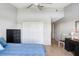 This bedroom has a ceiling fan, light wood floors and a closet with white doors at 435 Kensington Lake Crk, Brandon, FL 33511