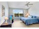 Bright bedroom with a large window, comfortable bed, wood laminate flooring, and ample natural light at 435 Kensington Lake Crk, Brandon, FL 33511