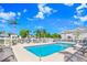 Community pool area with ample lounging space and shaded seating surrounded by palm trees at 435 Kensington Lake Crk, Brandon, FL 33511