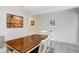 Dining area featuring a wooden table, white chairs, tiled floor, and coastal-themed artwork at 435 Kensington Lake Crk, Brandon, FL 33511