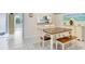 Dining area with a wooden table, white chairs, a bench, and sliding glass doors with a view of the outdoors at 435 Kensington Lake Crk, Brandon, FL 33511