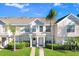 Charming townhouse exterior featuring a well-manicured lawn, and neutral colors, providing a welcoming curb appeal at 435 Kensington Lake Crk, Brandon, FL 33511