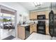 This kitchen features light wood cabinets and black appliances at 435 Kensington Lake Crk, Brandon, FL 33511