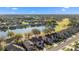 Aerial view overlooking houses, a lake, a golf course and lush green landscaping at 5039 Gato Del Sol Cir, Wesley Chapel, FL 33544