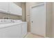 Laundry room with a white washer, dryer, and cabinets at 5039 Gato Del Sol Cir, Wesley Chapel, FL 33544