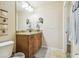 Cozy bathroom featuring a granite countertop vanity, mirror and beige walls at 5088 Royal Palms Way # 304, New Port Richey, FL 34652
