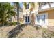 Exterior of home with white doors, green grass and palm tree at 5088 Royal Palms Way # 304, New Port Richey, FL 34652