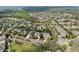 An aerial shot shows the suburban neighborhood, showcasing mature trees at 5305 Sagecrest Dr, Lithia, FL 33547