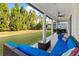 Cozy back porch with a blue couch, a ceiling fan, and a lush green lawn at 5305 Sagecrest Dr, Lithia, FL 33547