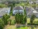 Aerial view of fenced backyard with mature landscaping and a covered patio at 5305 Sagecrest Dr, Lithia, FL 33547