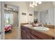 Bathroom features double sinks and a vanity with modern lighting fixtures at 5305 Sagecrest Dr, Lithia, FL 33547
