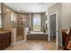 An ensuite bathroom features a glass enclosed shower, garden tub, and a separate water closet at 5305 Sagecrest Dr, Lithia, FL 33547