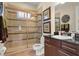 Tiled bathroom features glass-enclosed shower, modern vanity, and tasteful decor at 5305 Sagecrest Dr, Lithia, FL 33547