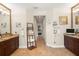 Bright bathroom offering dual sink vanities, tiled flooring and a hallway view at 5305 Sagecrest Dr, Lithia, FL 33547