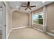 Spacious bedroom with a trey ceiling, recessed lighting, ceiling fan, and a large window at 5305 Sagecrest Dr, Lithia, FL 33547