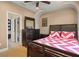 Bedroom with ceiling fan, dresser with mirror, and a view into the bathroom at 5305 Sagecrest Dr, Lithia, FL 33547