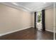 A bedroom with hardwood floors and a window with decorative curtains offers a calm retreat at 5305 Sagecrest Dr, Lithia, FL 33547