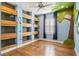 Unique bedroom with built-in shelving, hardwood floors, and a distinctive tree mural on the wall at 5305 Sagecrest Dr, Lithia, FL 33547