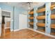 Bright bedroom with hardwood floors, built-in shelving, closet and connecting door to another room at 5305 Sagecrest Dr, Lithia, FL 33547