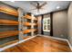 Bedroom featuring hardwood floors, built-in shelving, and a cozy window view at 5305 Sagecrest Dr, Lithia, FL 33547