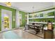 Bright dining room with wooden table and shelves, adjacent to the entryway at 5305 Sagecrest Dr, Lithia, FL 33547
