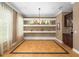 A dining area features decorative shelving, large windows, and a neutral color palette at 5305 Sagecrest Dr, Lithia, FL 33547