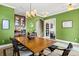 Open-concept dining area with green walls, view of a bar and a second living space at 5305 Sagecrest Dr, Lithia, FL 33547