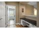 Hallway featuring a built-in desk and access to the laundry room with a view through to the backyard at 5305 Sagecrest Dr, Lithia, FL 33547
