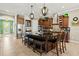 Open kitchen design with island seating, dark wood cabinetry, and stainless steel appliances at 5305 Sagecrest Dr, Lithia, FL 33547