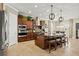 Spacious kitchen boasts dark wood cabinetry, a large island with seating, and modern stainless steel appliances at 5305 Sagecrest Dr, Lithia, FL 33547